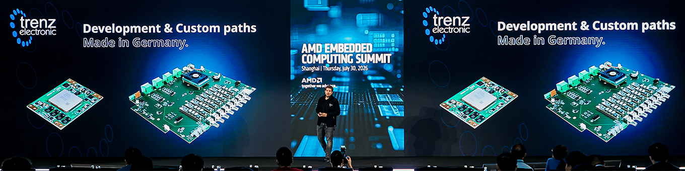 Bühnenaufnahme vom AMD Embedded Computing Summit mit Präsentation von Trenz Electronic zu Entwicklungs- und Custom-Lösungen sowie FPGA- und SoC-Hardware.